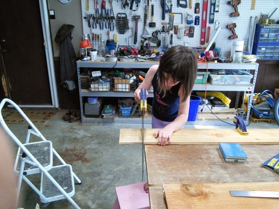 Graydon sawing the cedar board