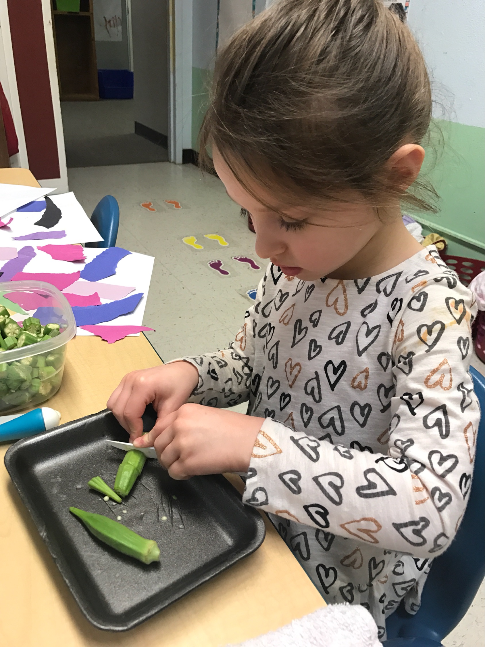 Charlie Kate cuts okra